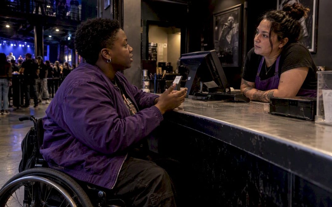 Attendee asks staff about accessible concert seats