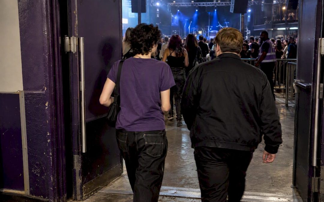 Fans entering a concert floor through open doors